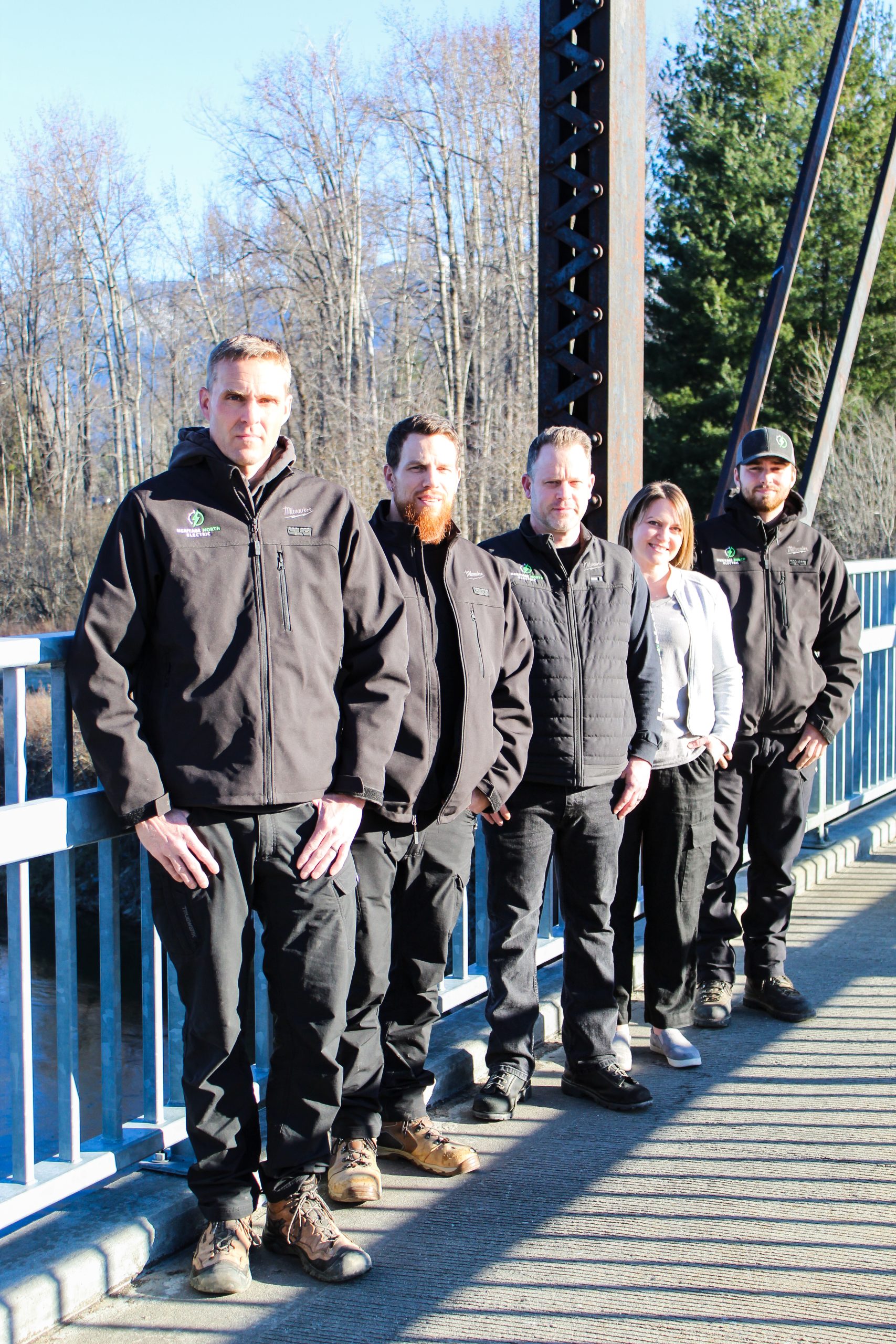 The Heritage North Electric team on a Sandpoint river bridge